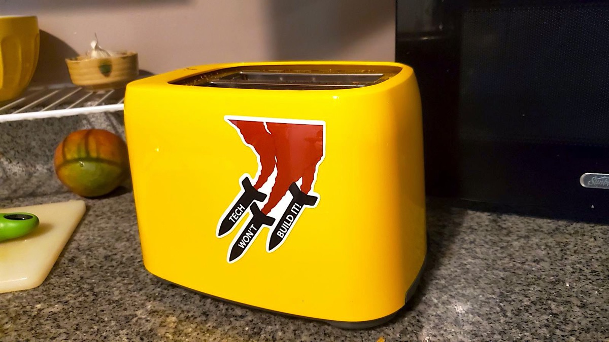 A photo of a toaster with a sticker reading Tech Won't Build It